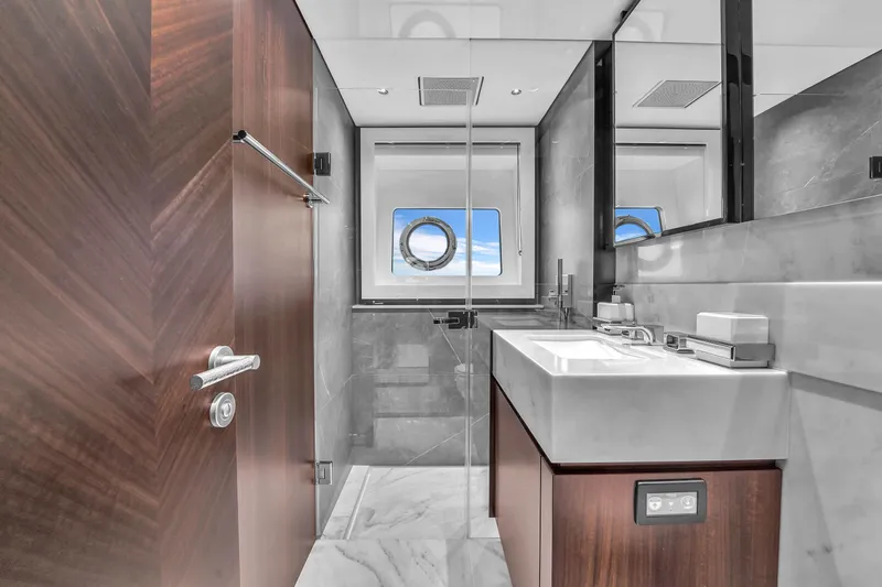 Worth The Wait Yacht Photos Pics Luxurious bathroom in 2024 Sunseeker Ocean 182 yacht with modern fixtures and ocean view.