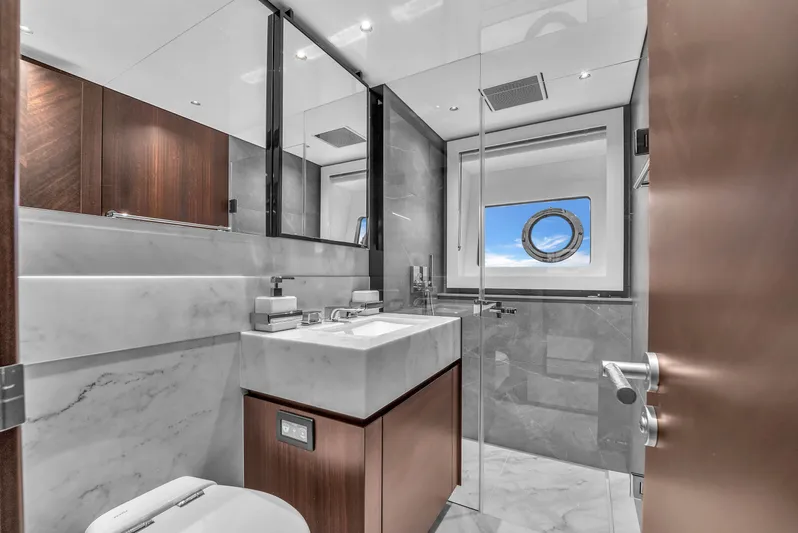 Worth The Wait Yacht Photos Pics Luxurious bathroom in 2024 Sunseeker Ocean 182 yacht with modern fixtures and ocean view.