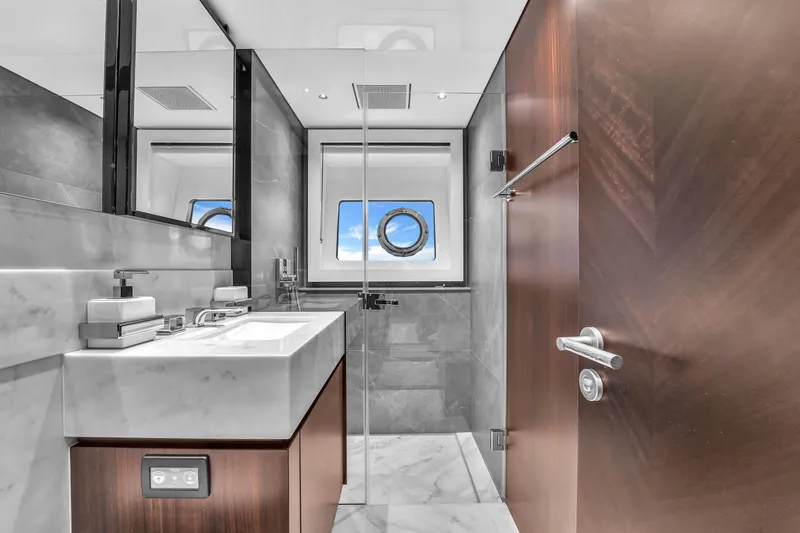 Worth The Wait Yacht Photos Pics Luxurious bathroom in 2024 Sunseeker Ocean 182 yacht with modern fixtures and ocean view.