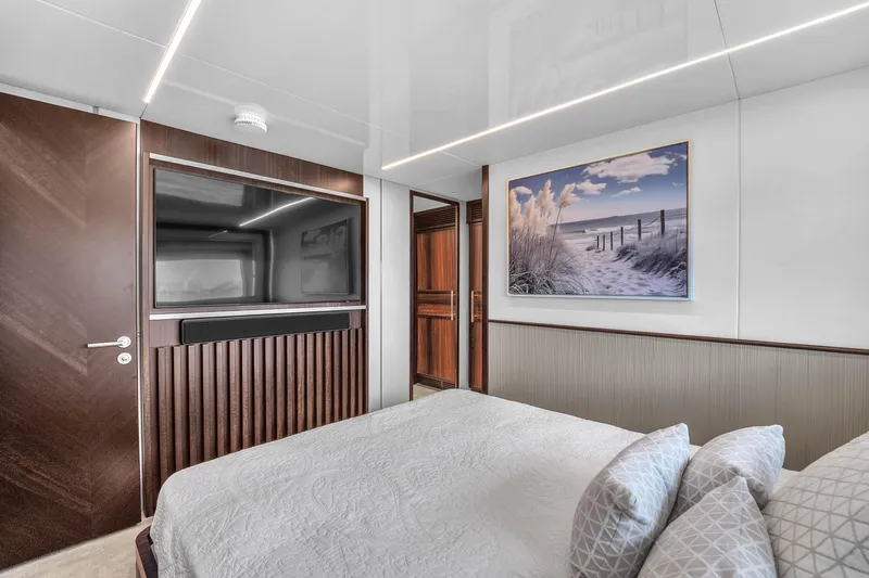 Worth The Wait Yacht Photos Pics Luxurious bedroom interior of 2024 Sunseeker Ocean 182 yacht with modern decor.