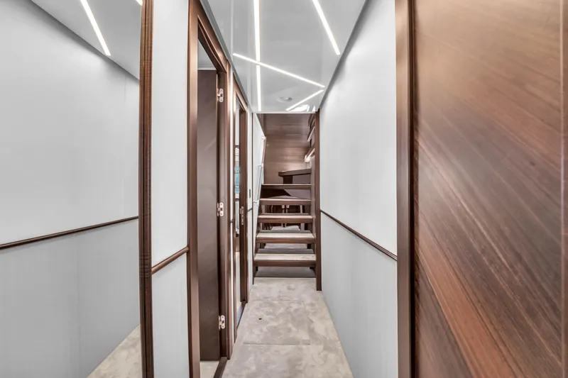 Worth The Wait Yacht Photos Pics Luxurious interior hallway of 2024 Sunseeker Ocean 182 yacht with modern design.