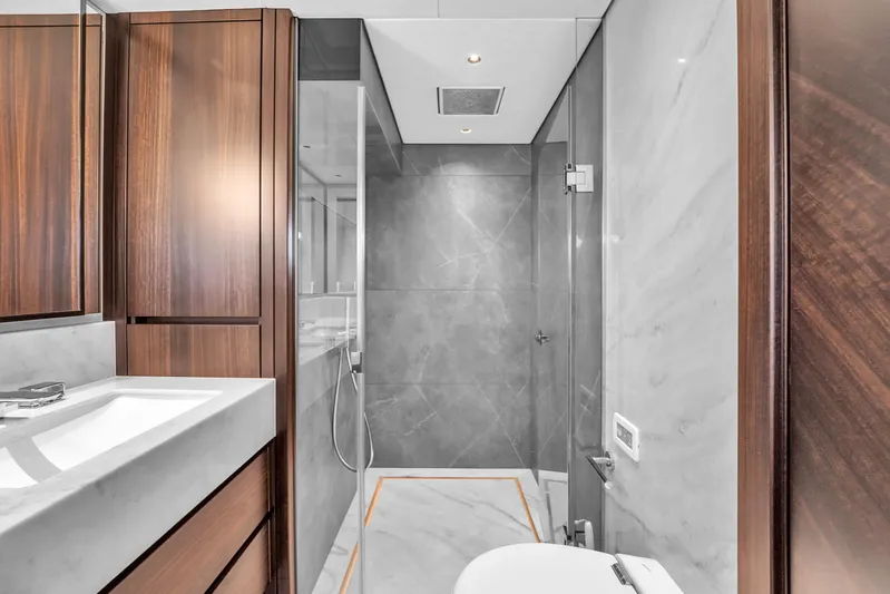 Worth The Wait Yacht Photos Pics Luxurious bathroom in 2024 Sunseeker Ocean 182 yacht with modern design and wood accents.