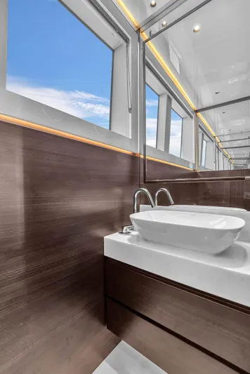 Worth The Wait Yacht Photos Pics Luxurious bathroom interior of 2024 Sunseeker Ocean 182 yacht with modern sink and large windows.