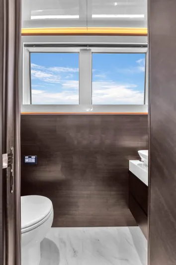 Worth The Wait Yacht Photos Pics Luxurious bathroom in 2024 Sunseeker Ocean 182 yacht with modern fixtures and ocean view.