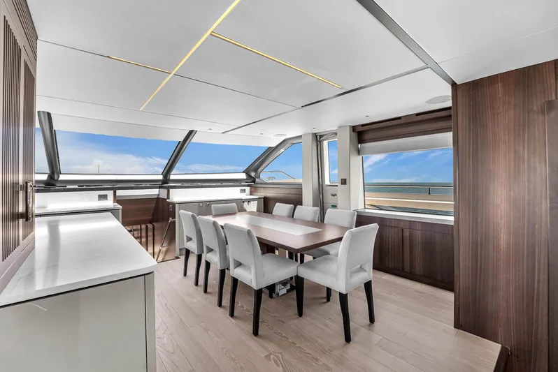 Worth The Wait Yacht Photos Pics Luxurious interior of 2024 Sunseeker Ocean 182 yacht with elegant dining area and panoramic windows.