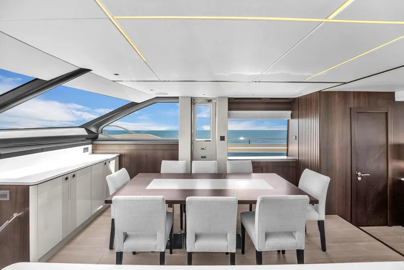 Worth The Wait Yacht Photos Pics Luxurious interior of 2024 Sunseeker Ocean 182 yacht with ocean view and elegant dining area.