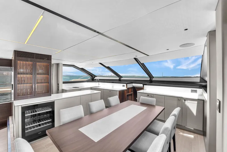 Worth The Wait Yacht Photos Pics Luxurious interior of 2024 Sunseeker Ocean 182 yacht with modern dining area and panoramic windows.
