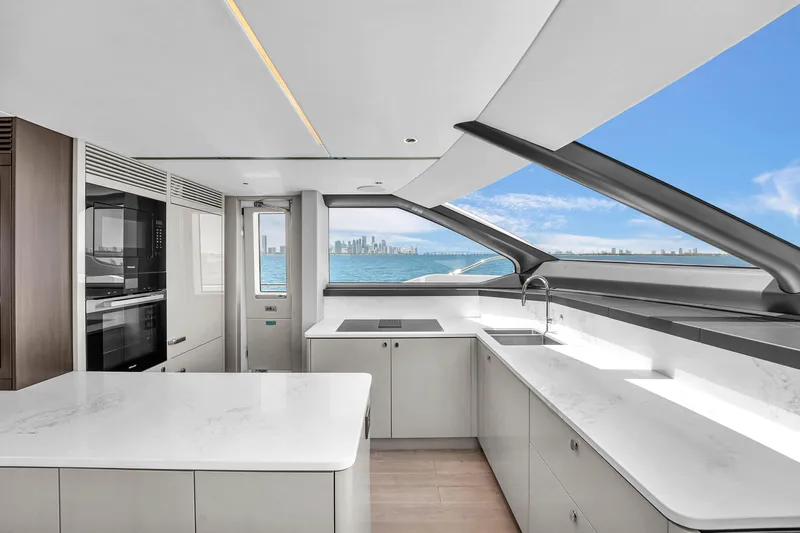 Worth The Wait Yacht Photos Pics Luxurious Sunseeker Ocean 182 yacht kitchen with modern design and ocean view, 2024 model.