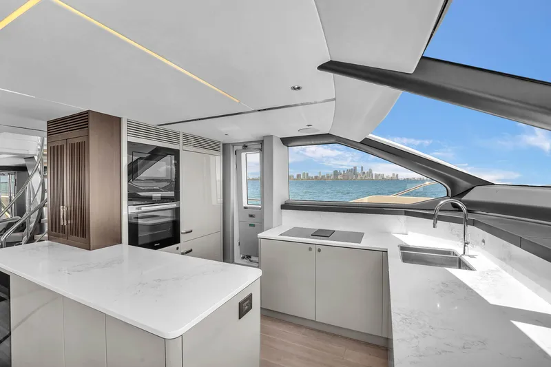 Worth The Wait Yacht Photos Pics Luxurious Sunseeker Ocean 182 yacht interior with modern kitchen and ocean view, 2024 model.