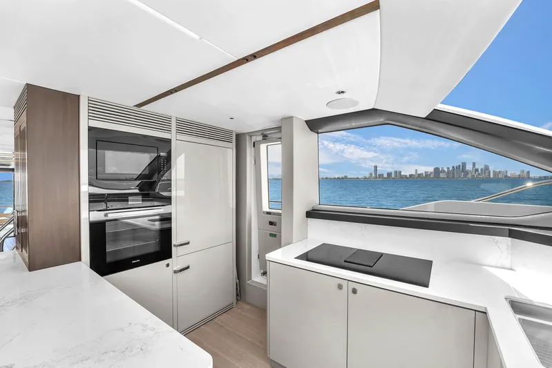 Worth The Wait Yacht Photos Pics Luxurious Sunseeker Ocean 182 yacht kitchen with modern appliances and stunning ocean view, 2024 model.