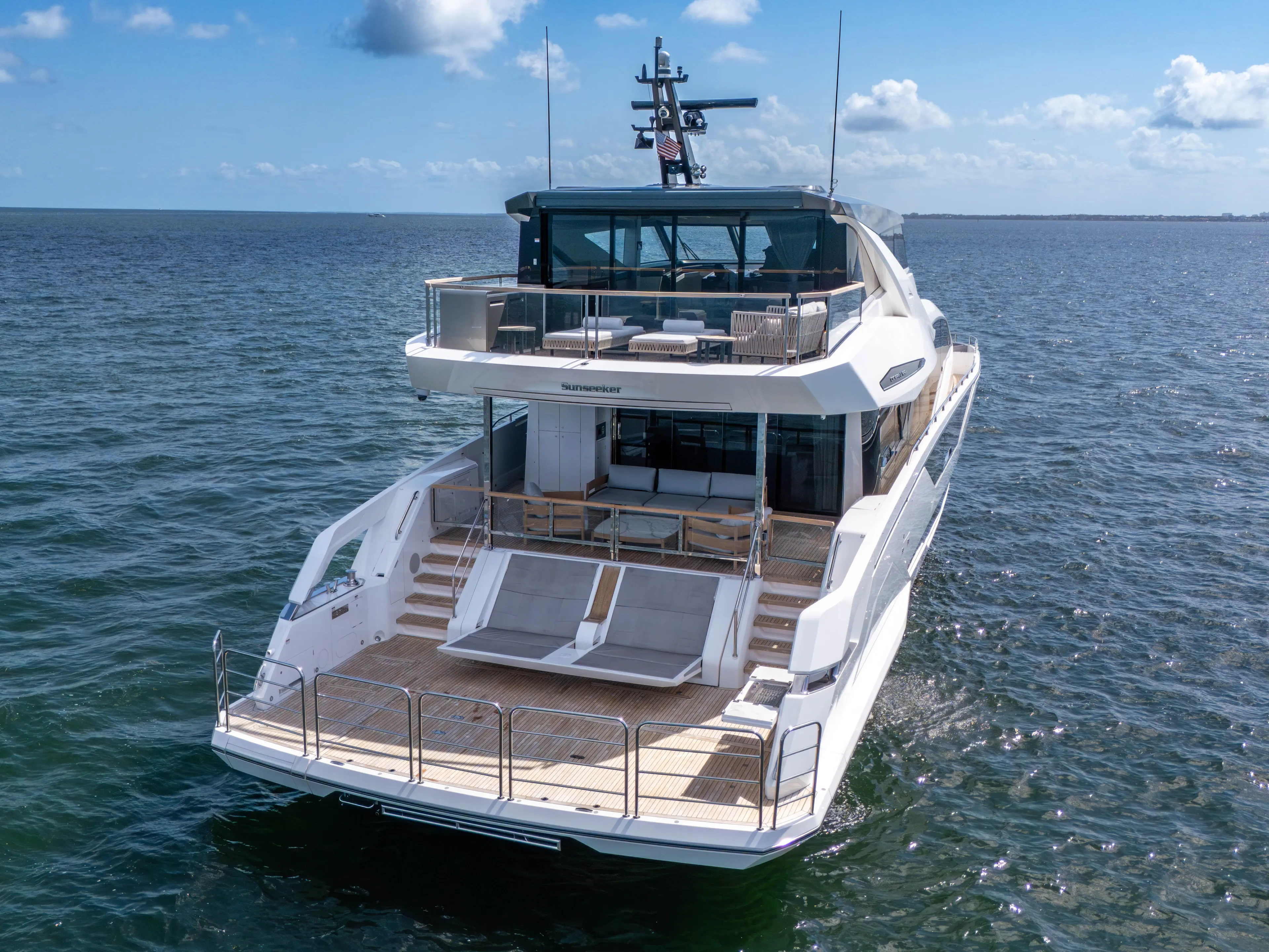 Worth The Wait Yacht Photos Pics 2024 Sunseeker Ocean 182 yacht on open water, rear view, sunny day.