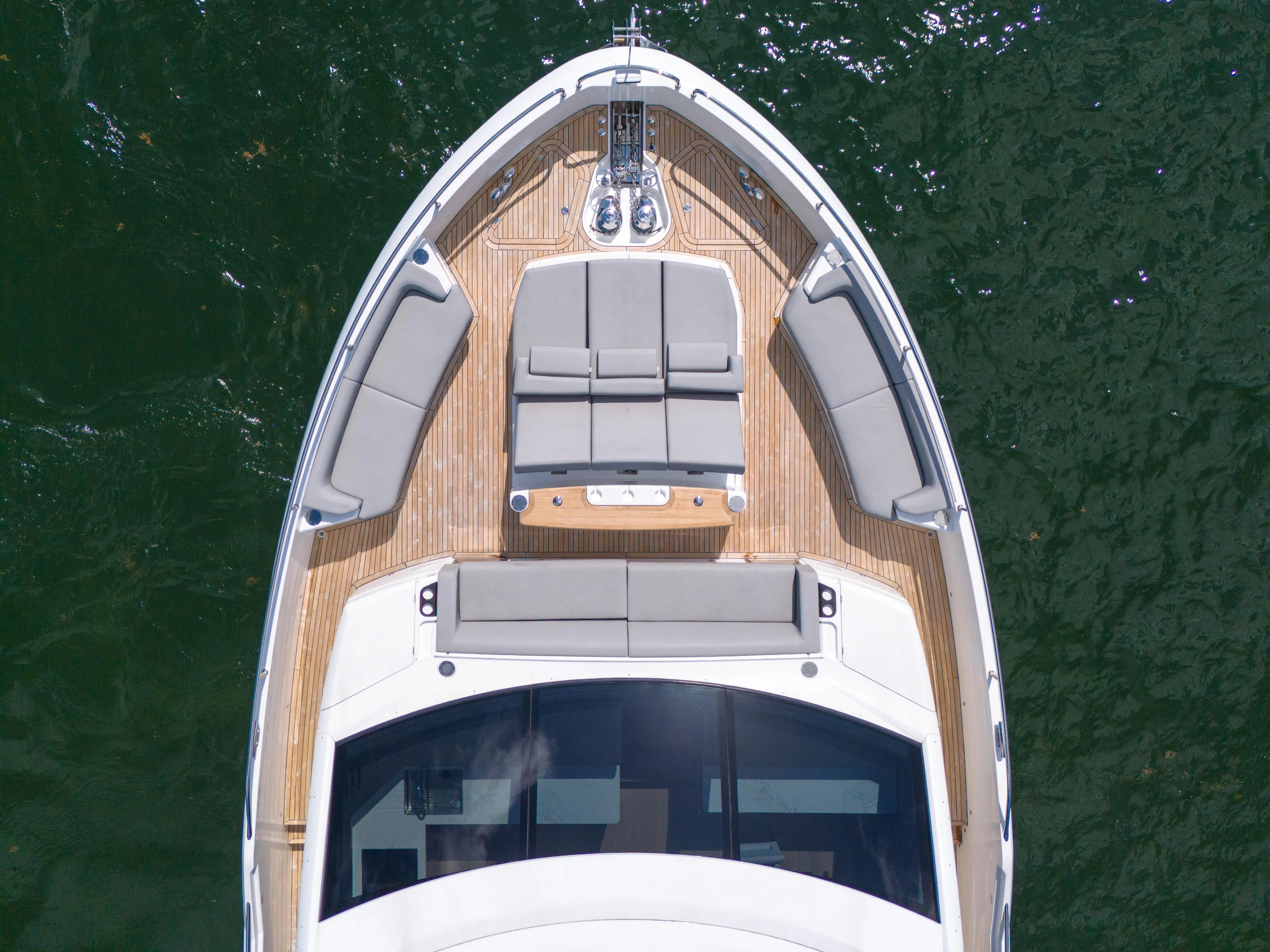 Worth The Wait Yacht Photos Pics 2024 Sunseeker Ocean 182 yacht, aerial view of deck with seating, on water.