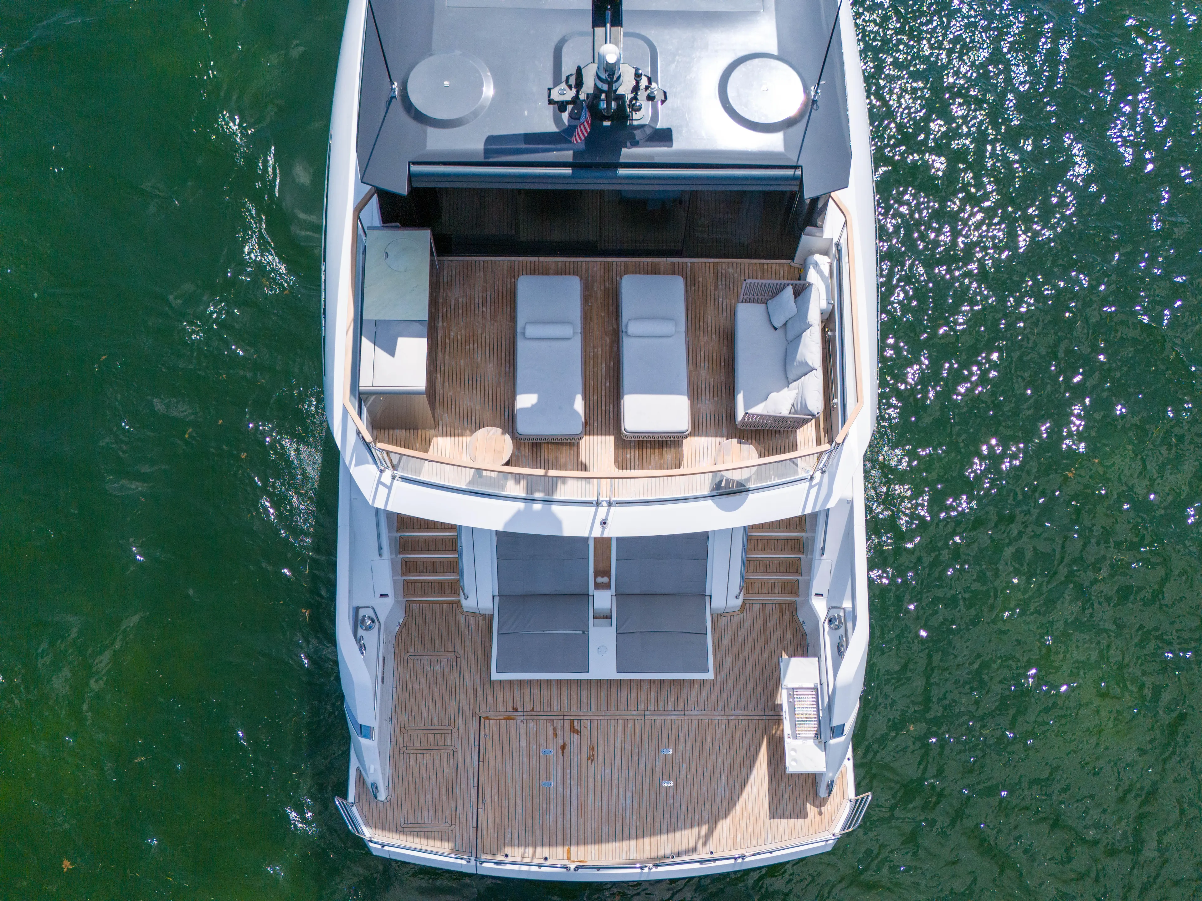 Worth The Wait Yacht Photos Pics 2024 Sunseeker Ocean 182 yacht, aerial view, showcasing spacious deck and luxurious seating.