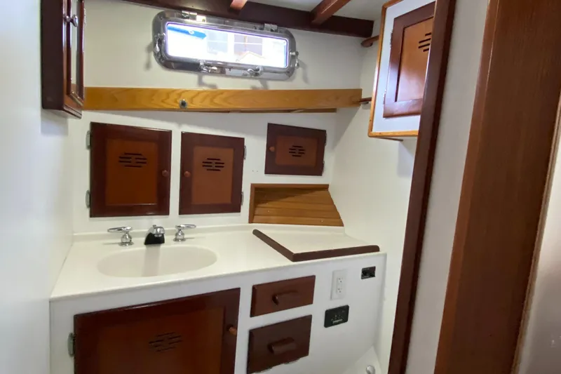 Lord Stanley Yacht Photos Pics 1988 Lyman-Morse Jarvis Newman cruiser bathroom with wooden cabinets and sink.