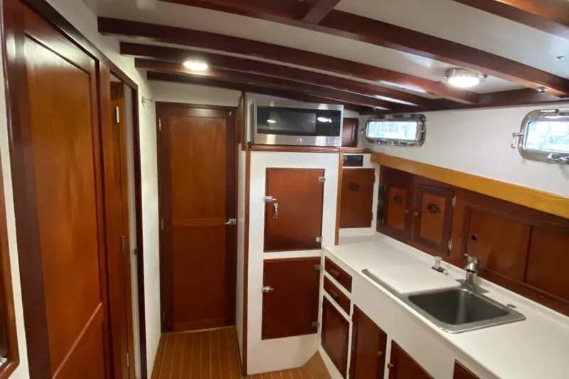 Lord Stanley Yacht Photos Pics 1988 Lyman-Morse Jarvis Newman Lobster Cruiser interior with wood cabinetry and modern amenities.