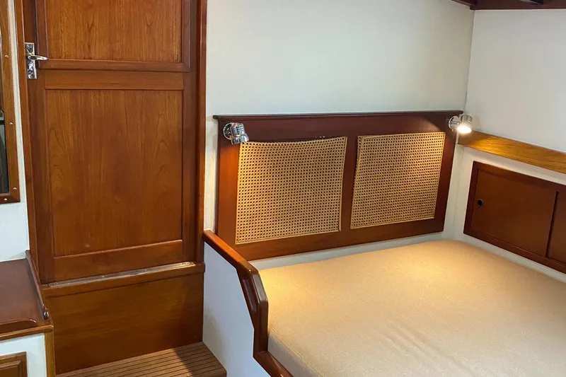 Lord Stanley Yacht Photos Pics 1988 Lyman-Morse Jarvis Newman Lobster Cruiser interior with wooden cabinetry and cozy sleeping area.