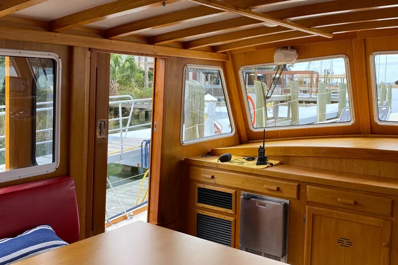 Lord Stanley Yacht Photos Pics Interior of 1988 Lyman-Morse Jarvis Newman Lobster Style Cruiser with wooden cabinetry and marina view.