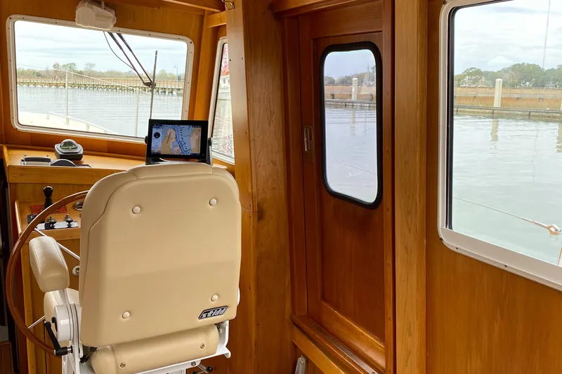 Lord Stanley Yacht Photos Pics 1988 Lyman-Morse Jarvis Newman Lobster Cruiser interior with helm, wooden finish, and water view.