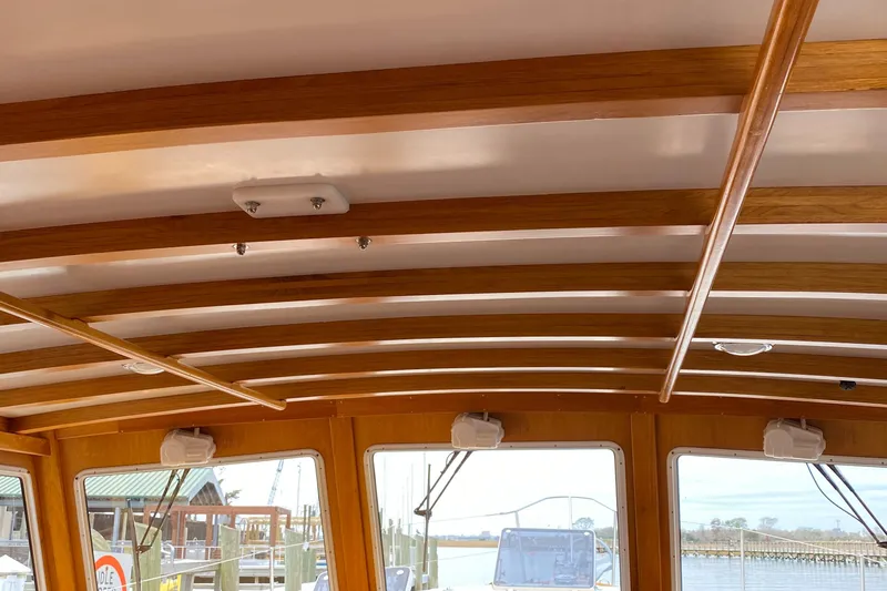 Lord Stanley Yacht Photos Pics 1988 Lyman-Morse Jarvis Newman Lobster Cruiser interior with wooden beams and windows.