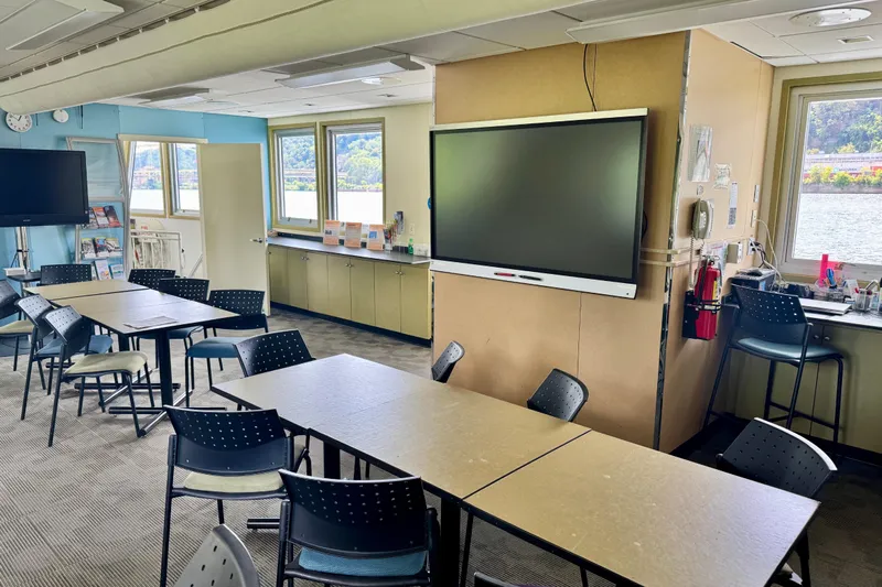 M/v Explorer Yacht Photos Pics Modern research riverboat interior with tables, chairs, and large screens, 2016 model.