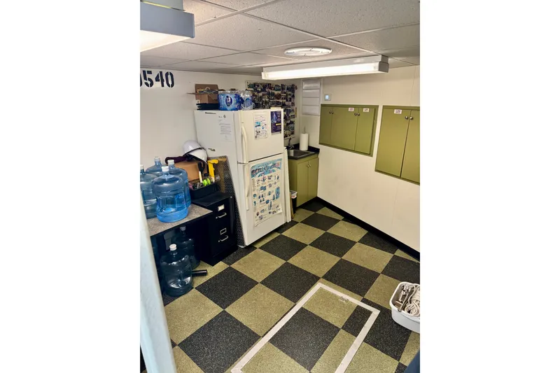 M/v Explorer Yacht Photos Pics Interior of 2016 custom commercial research riverboat with checkered floor and storage cabinets.