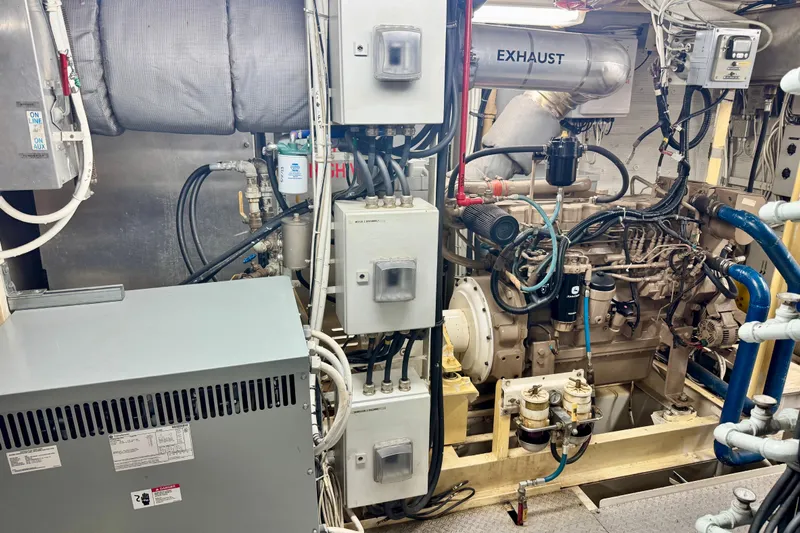 M/v Explorer Yacht Photos Pics Engine room of a 2016 Custom Commercial Research Riverboat, showcasing complex machinery and exhaust system.