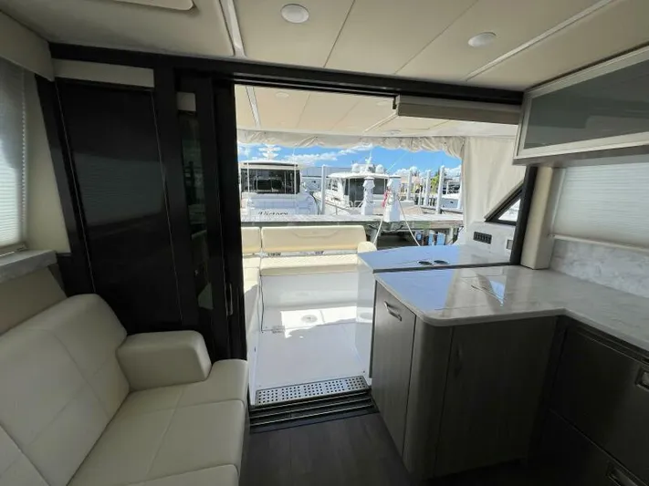 Great Expectations Yacht Photos Pics Interior view of 2020 Regal 38 XO yacht with marina backdrop.