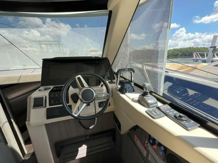 Great Expectations Yacht Photos Pics 2020 Regal 38 XO yacht helm with steering wheel and control panel.