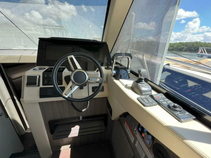 Great Expectations Yacht Photos Pics 2020 Regal 38 XO yacht helm with steering wheel and control panel under sunny skies.
