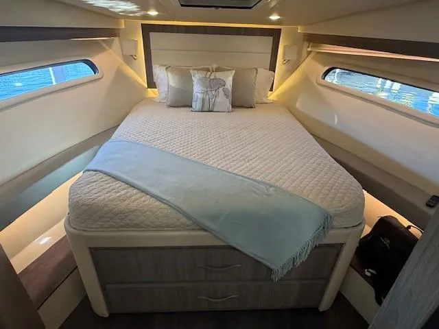 Great Expectations Yacht Photos Pics Luxurious cabin interior of 2020 Regal 38 XO yacht with cozy bed and windows.