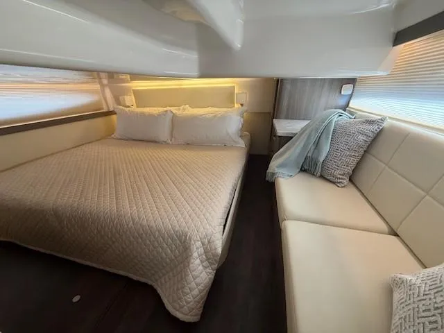 Great Expectations Yacht Photos Pics Luxurious interior of 2020 Regal 38 XO yacht with cozy bed and seating area.