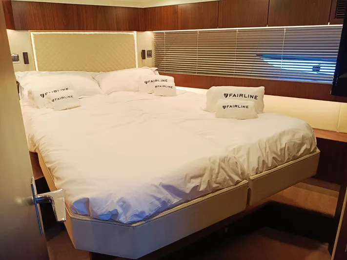 Waypoint Yacht Photos Pics Luxurious bedroom interior of 2024 Fairline Squadron 50 yacht with elegant bedding.