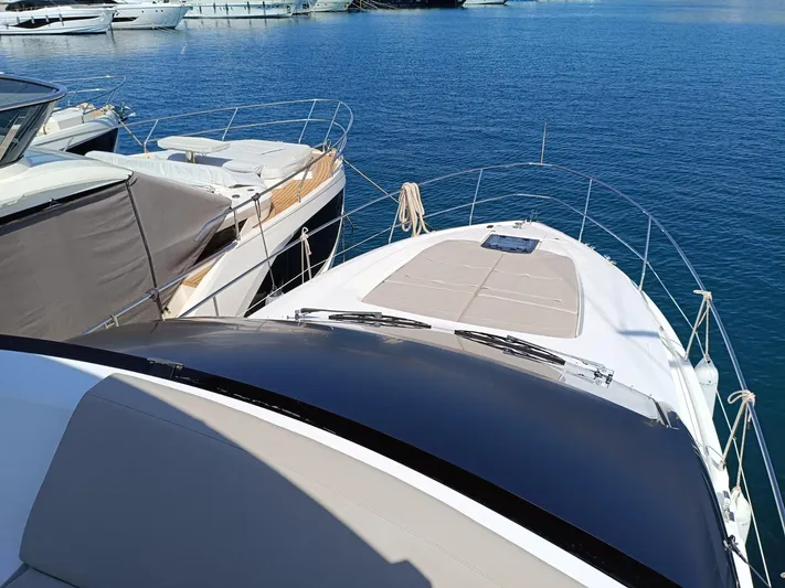 Waypoint Yacht Photos Pics 2024 Fairline Squadron 50 yacht docked in a marina, showcasing sleek design and luxury.