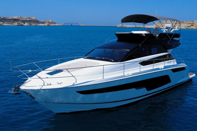 Waypoint Yacht Photos Pics 2024 Fairline Squadron 50 yacht on calm blue waters, showcasing sleek design and luxury.