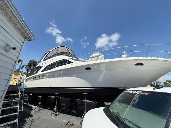 Yacht Photos Pics 2006 Sea Ray 52 Sedan Bridge yacht on dry dock under clear blue sky.