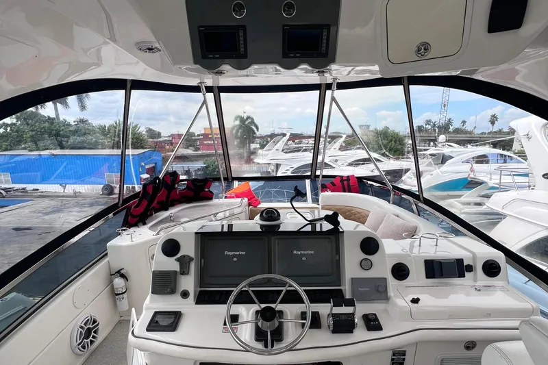  Yacht Photos Pics 2006 Sea Ray 52 Sedan Bridge helm with navigation equipment and marina view.