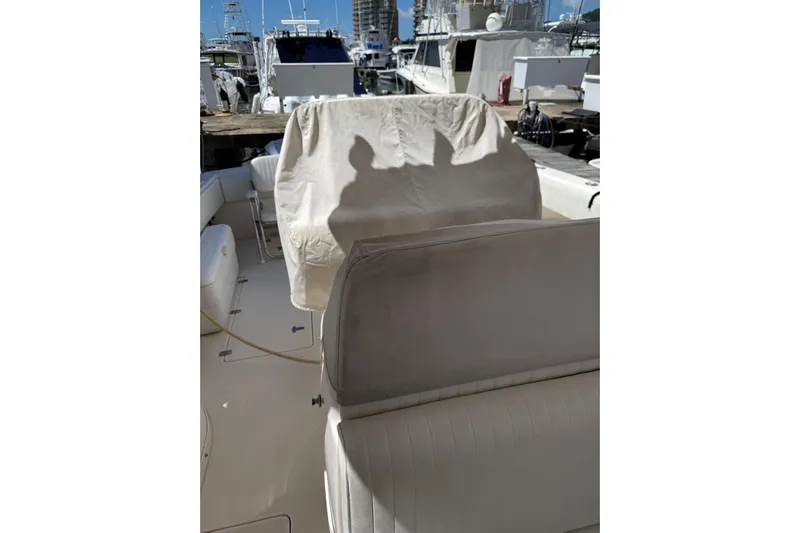 Chapuzon III Yacht Photos Pics 2001 Intrepid 377 Walkaround boat interior with covered seats at a marina.