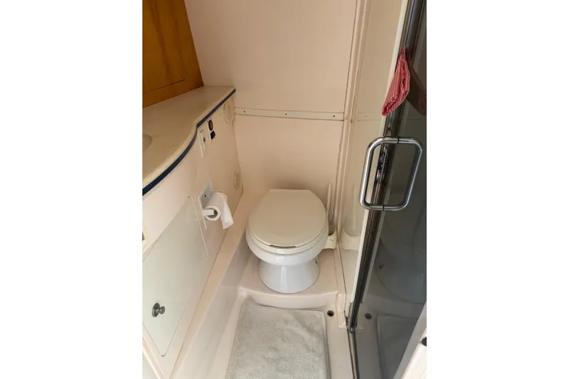Chapuzon III Yacht Photos Pics 2001 Intrepid 377 Walkaround boat bathroom with toilet, shower, and sink.