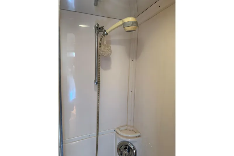 Chapuzon III Yacht Photos Pics Shower area in 2001 Intrepid 377 Walkaround boat, featuring handheld showerhead.