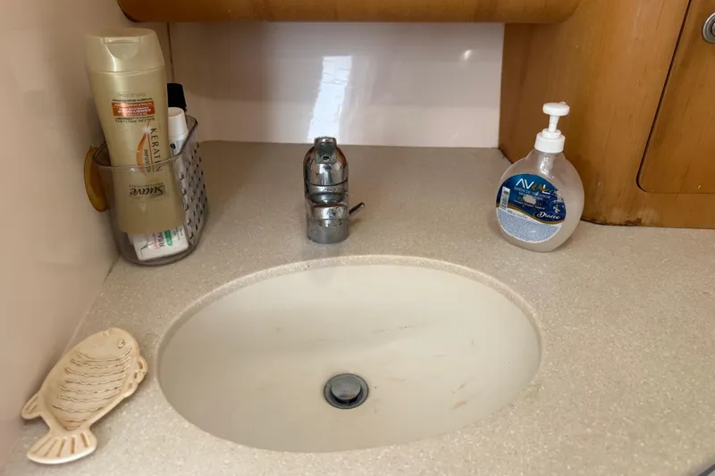 Chapuzon III Yacht Photos Pics Bathroom sink area on a 2001 Intrepid 377 Walkaround boat with toiletries.