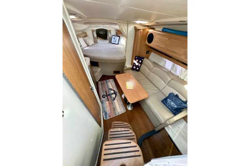 Carpe Diem Yacht Photos Pics 2015 Rinker 340 Express Cruiser interior with cozy seating and elegant wood finishes.