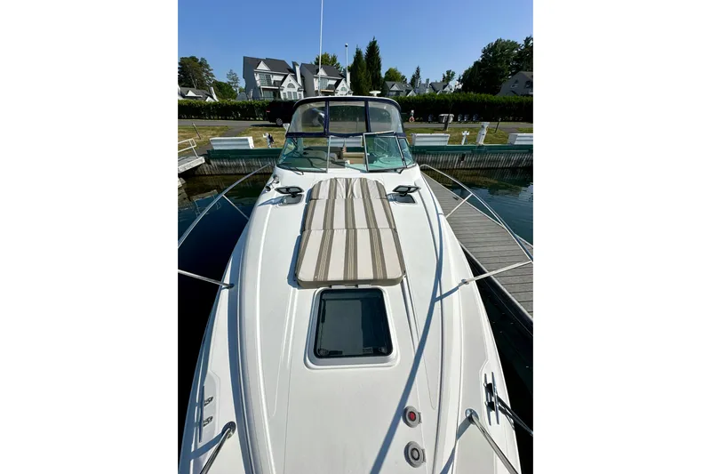 Carpe Diem Yacht Photos Pics 2015 Rinker 340 Express Cruiser docked at marina, showcasing sleek design and spacious deck.