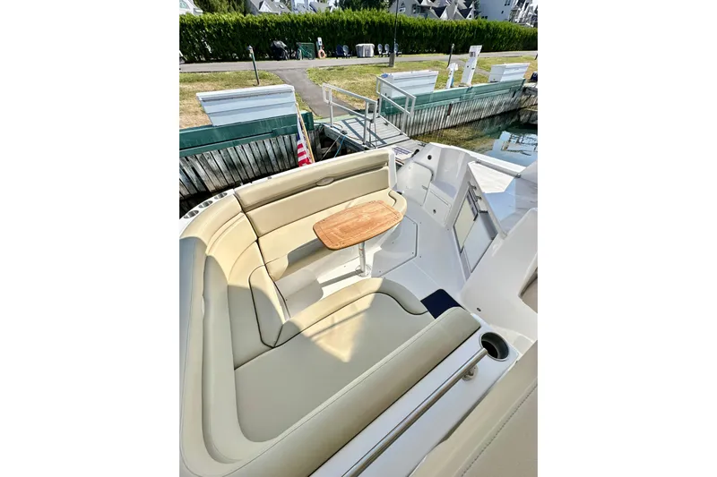 Carpe Diem Yacht Photos Pics 2015 Rinker 340 Express Cruiser interior with beige seating and wooden table.
