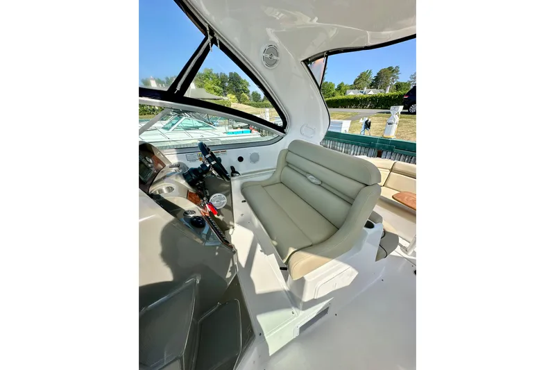 Carpe Diem Yacht Photos Pics 2015 Rinker 340 Express Cruiser helm with beige seating and modern controls.
