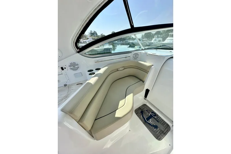 Carpe Diem Yacht Photos Pics 2015 Rinker 340 Express Cruiser interior with beige seating and window view.