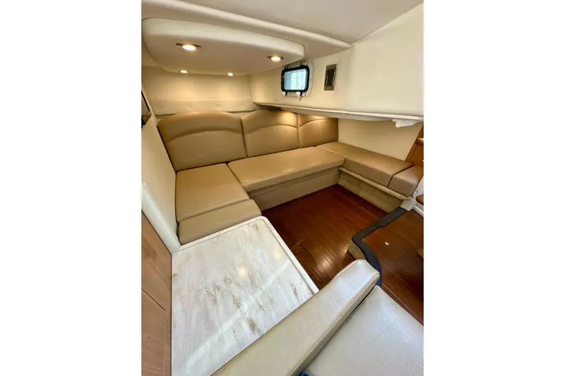Carpe Diem Yacht Photos Pics 2015 Rinker 340 Express Cruiser interior with beige seating and wooden flooring.