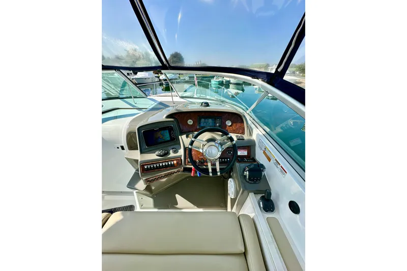 Carpe Diem Yacht Photos Pics 2015 Rinker 340 Express Cruiser helm with modern controls and navigation system.