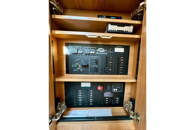 Carpe Diem Yacht Photos Pics Electrical panel of 2015 Rinker 340 Express Cruiser, featuring control switches and circuit breakers.