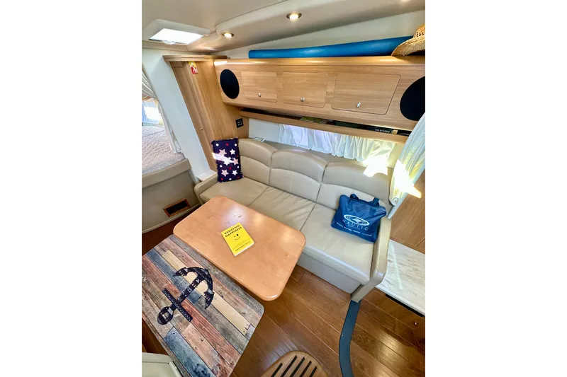 Carpe Diem Yacht Photos Pics Interior of 2015 Rinker 340 Express Cruiser with cozy seating and nautical decor.