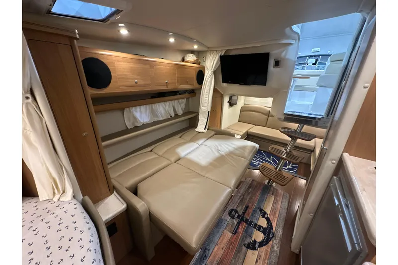 Carpe Diem Yacht Photos Pics Luxurious interior of 2015 Rinker 340 Express Cruiser with leather seating and modern amenities.